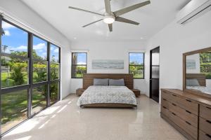 a bedroom with a bed and a ceiling fan at Intimate Paradise-Pool, Terrace & Private Bedrooms in San Juan