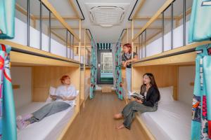 a group of people sitting on bunk beds in a bus at Lub d Bangkok Chinatown - Steps from Sam Yod MRT Station in Bangkok