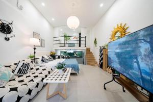a living room with a large screen tv and a couch at 柃居 B&B - Huaihai Middle Road Branch in Shanghai
