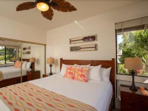 a bedroom with a bed and a large window at Wailea Grand Champions 84 in Wailea +35 photos