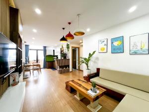a living room with a couch and a table at 2BR Apartment by My Khe Beach - Beachfront escape in Da Nang
