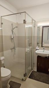 une salle de bain avec une douche, des toilettes et un lavabo dans l'établissement Ocean Paradise Luxury, à Nikawatawana