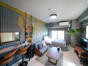 a room with a bedroom with a bed and a television at REVISION Ebiyama-tei - Vacation STAY 15811 in Hiroshima