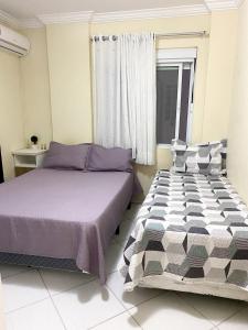 Postel nebo postele na pokoji v ubytování Apartamento Balneário Camboriú + 12 fotografií