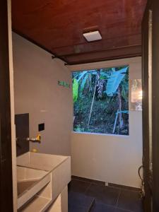 a bathroom with a large window and a sink at Loft, total tranquility in Dosquebradas +14 photos