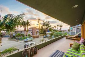 a balcony with a view of a street and palm trees at GrandView in Encinitas