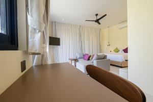 a hotel room with a table and a bed at Villa Dua Sungai in Sempidi
