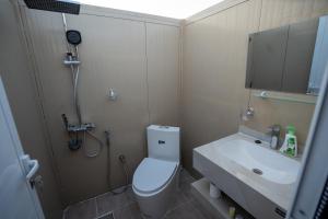 a bathroom with a toilet and a sink and a shower at Atana bidiyah private camp in Al Raka