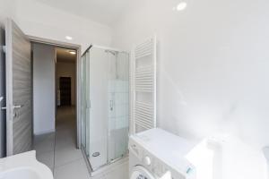 a white bathroom with a shower and a sink at Rubiera Residence - H24 in Zimella +95 photos