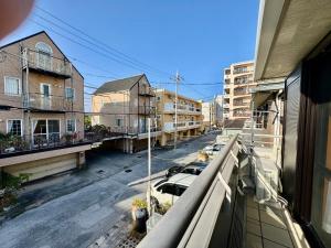een balkon met uitzicht op een stadsstraat bij ヴィラ マイラニハウス沖縄 in Hamakawa