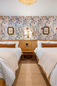 JasperにあるSommer House Inn-Garden Roomのベッド2台とテーブルが備わる客室です。