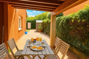 a wooden table with food and drinks on a patio at Casa Vixoi, a 5Km Catedral in Santiago de Compostela