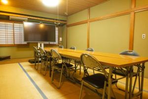 a conference room with a large table and chairs at MUST WIN Hotel in Takasaki