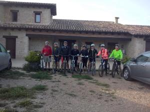 a group of people on bikes in front of a house at La Contrada in Arens de Lledó