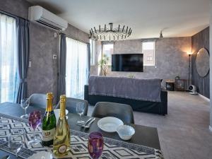 a living room with a table with wine bottles at VOGUE C, a private inn with a panoramic view of th - Vacation STAY 14693v in Isumi