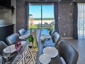 a dining room table with wine bottles and glasses at VOGUE C, a private inn with a panoramic view of th - Vacation STAY 14693v in Isumi
