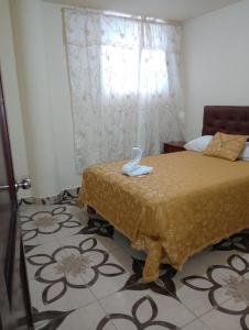 Ένα ή περισσότερα κρεβάτια σε δωμάτιο στο Hospedaje El Obraje