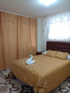 Ένα ή περισσότερα κρεβάτια σε δωμάτιο στο Hospedaje El Obraje