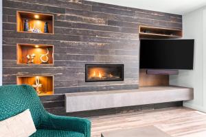 A television and/or entertainment centre at Englewood Greens 40 by Outpost Whistler