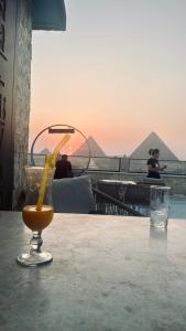 a drink sitting on a table with a banana at AB Grand museum view hotel in Cairo