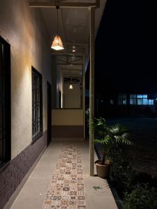 a hallway of a house at night with a potted plant at Mangal Srushti Agro Tourism 