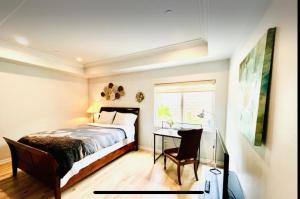 a bedroom with a bed and a desk and a window at Rowland Heights in Rowland Heights