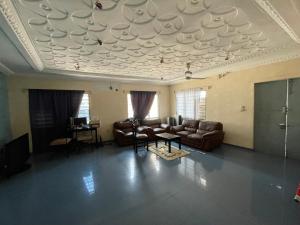 a living room with a couch and a table at Résidence HSN in Cococodji