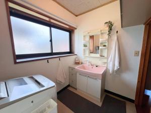 a bathroom with a sink and a window at Snowshine House - Family Friendly in Joetsu +12 photos