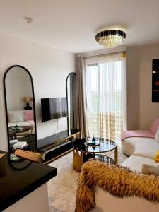 a living room with a couch and a mirror at Snyder luxe homes 1 in Tatu City