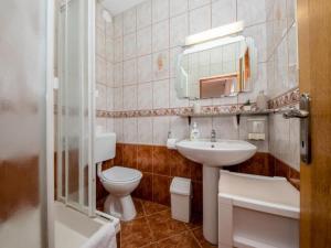 a bathroom with a sink and a toilet and a mirror at Apartments Scerbe Gordana & Miljenko Rab - Two Bedroom Apartment with Terrace 1 in Otok Rab +14 photos