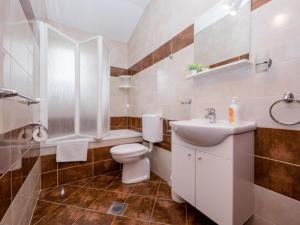 a white bathroom with a toilet and a sink at Apartments Scerbe Gordana & Miljenko Rab - Three Bedroom Apartment with Terrace 2 in Otok Rab +16 photos