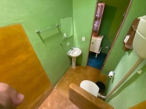 a bathroom with a toilet and a sink and a mirror at Pousada do Caminho Trancoso in Porto Seguro +62 photos