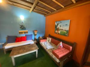 a living room with a couch and a table at Pousada do Caminho Trancoso in Porto Seguro