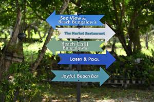 a street sign with arrows pointing in different directions at Pawapi Beach Resort in Ko Muk