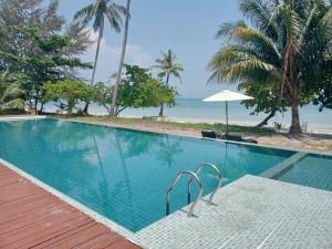 a swimming pool with a view of the beach at Pawapi Beach Resort in Ko Muk