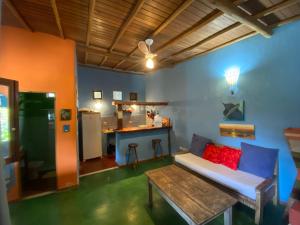 a living room with a couch and a table at Pousada do Caminho Trancoso in Porto Seguro