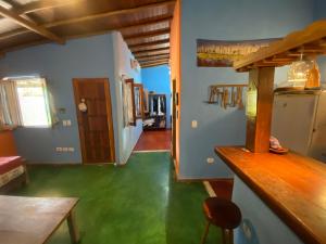 a living room with a green floor and a table at Pousada do Caminho Trancoso in Porto Seguro +62 photos