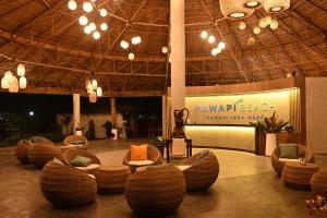 a lobby with chairs and a sign in a building at Pawapi Beach Resort in Ko Muk