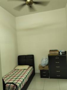 a bedroom with a bed and a ceiling fan at Adeline's Homestay Balik Pulau in Balik Pulau