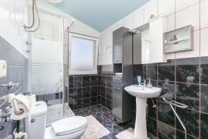 a bathroom with a toilet and a sink at Apartments with parking space Kastel Stafilic, Kastela - 24155 in Kaštela +37 photos