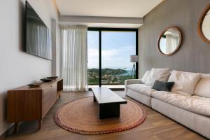 a living room with a couch and a table at El Cielo Sayulita in Sayulita