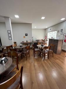 a restaurant with tables and chairs in a room at Morada do Lago in Palmas