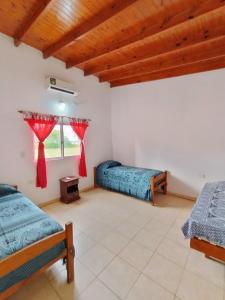 a room with two beds and a window at Cabañas Punta Iglesia 4 in Paso de la Patria