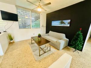 a living room with a couch and a table at Large 5 Bedrooms Home in Bayamon Puerto Rico in Bayamon
