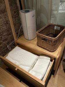 a shelf with towels and a wicker basket on it at The Heritage 1937 in Kuching +28 photos