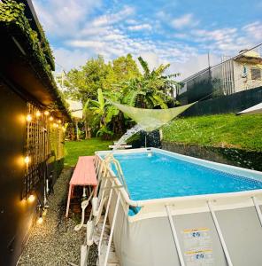 a pool in a backyard with a table and a fountain at New Best Deal 2 Bedroom Apartment in Bayamon, By RentalsPR in Bayamon
