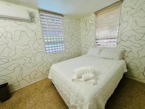 a bedroom with a bed with two towels on it at New Best Deal 2 Bedroom Apartment in Bayamon, By RentalsPR in Bayamon +31 photos