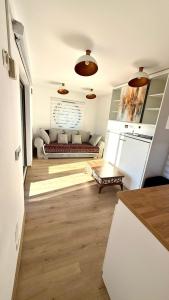 a living room with a couch in the middle at Badash Tiny Village in Polovragi