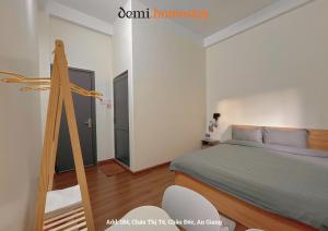 a bedroom with a bed with a wooden frame at DeMi Homestay 2 - Châu Đốc in áº¤p VÄ©nh ÃÃ´ng +18 photos