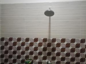 a room with a bench with a light on the ceiling at GG Lodge in Guwahati